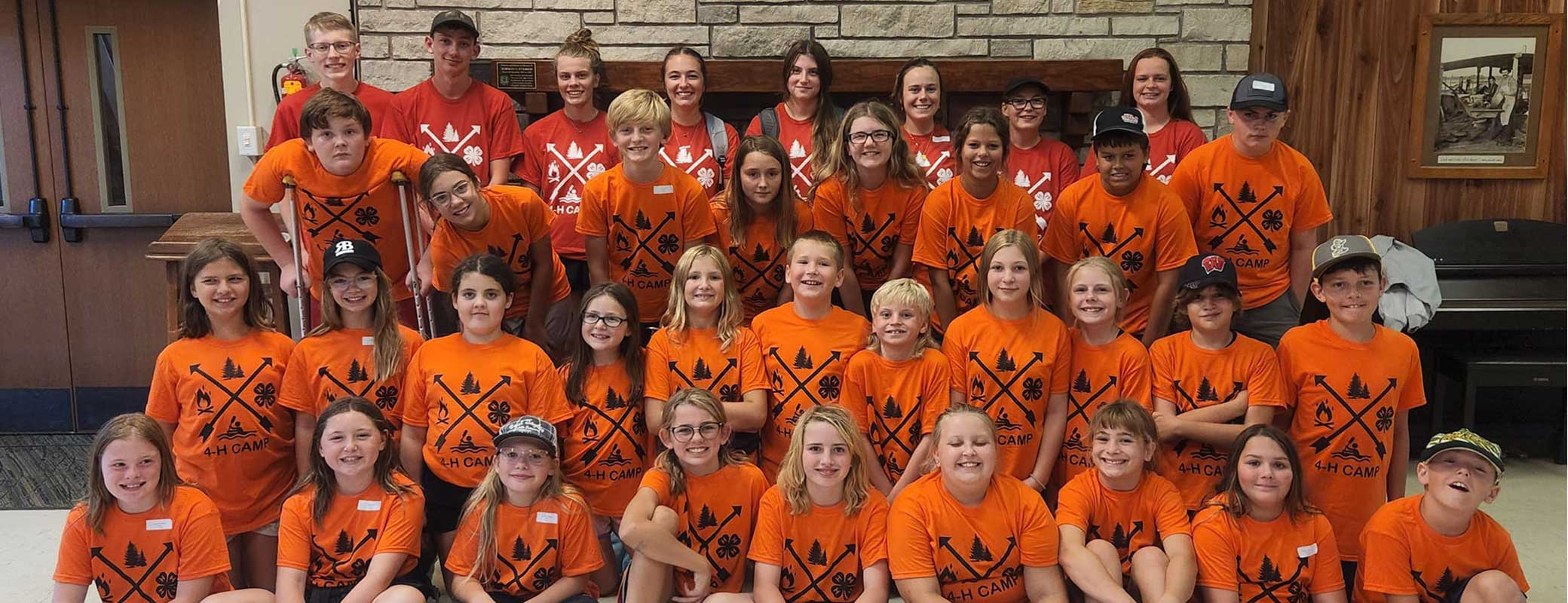 A large group of kids with orange 4-H t-shirts on