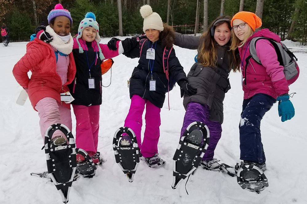 5 children wearing snowshoes
